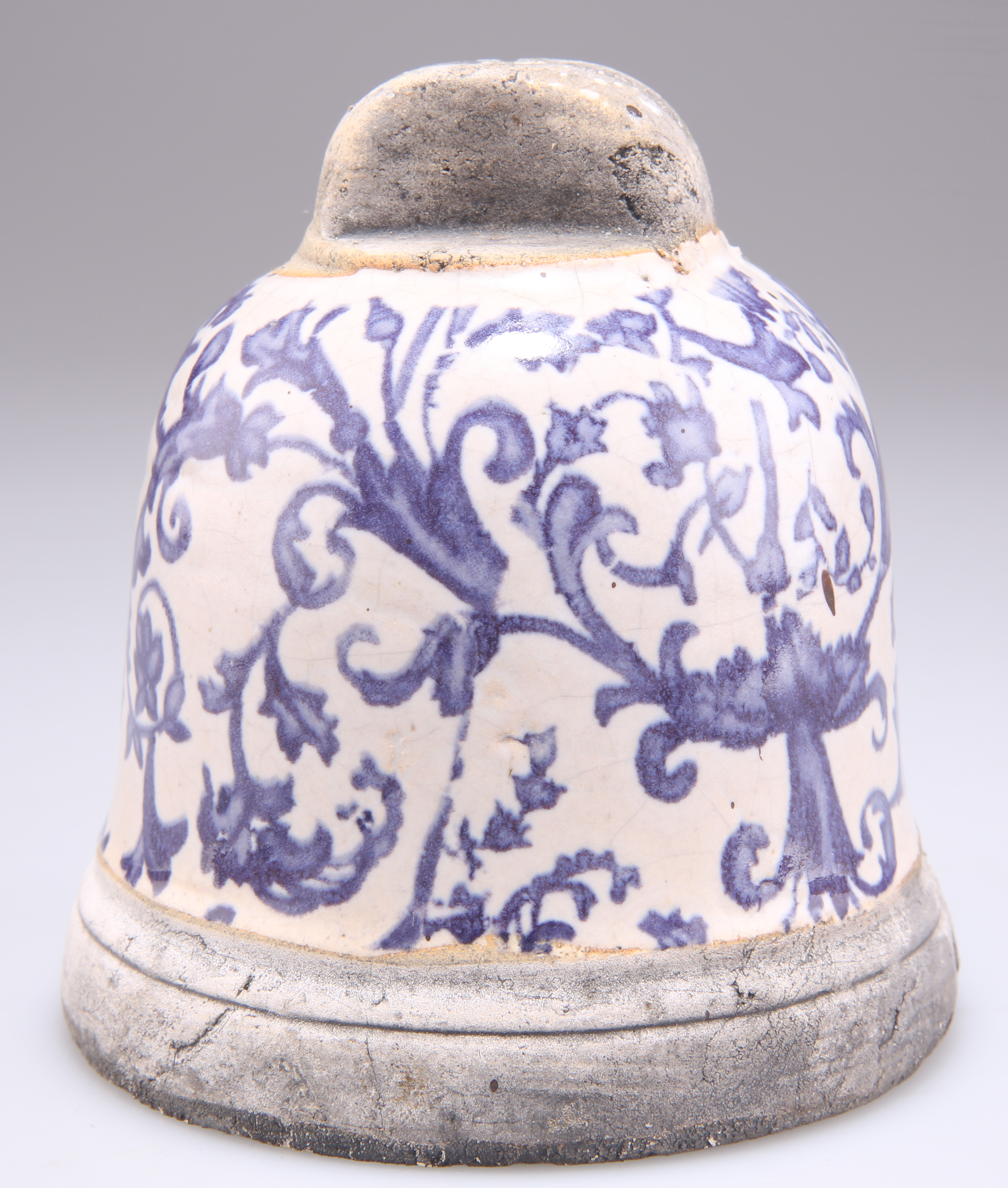 A BLUE AND WHITE POTTERY BELL