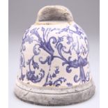 A BLUE AND WHITE POTTERY BELL