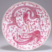 A CHINESE PUCE DECORATED 'DRAGON AND PHOENIX' DISH