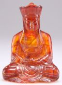 AN AMBER COLOURED FIGURE OF A BUDDHA