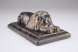 A 19TH CENTURY BRONZE OF A RECUMBENT LION