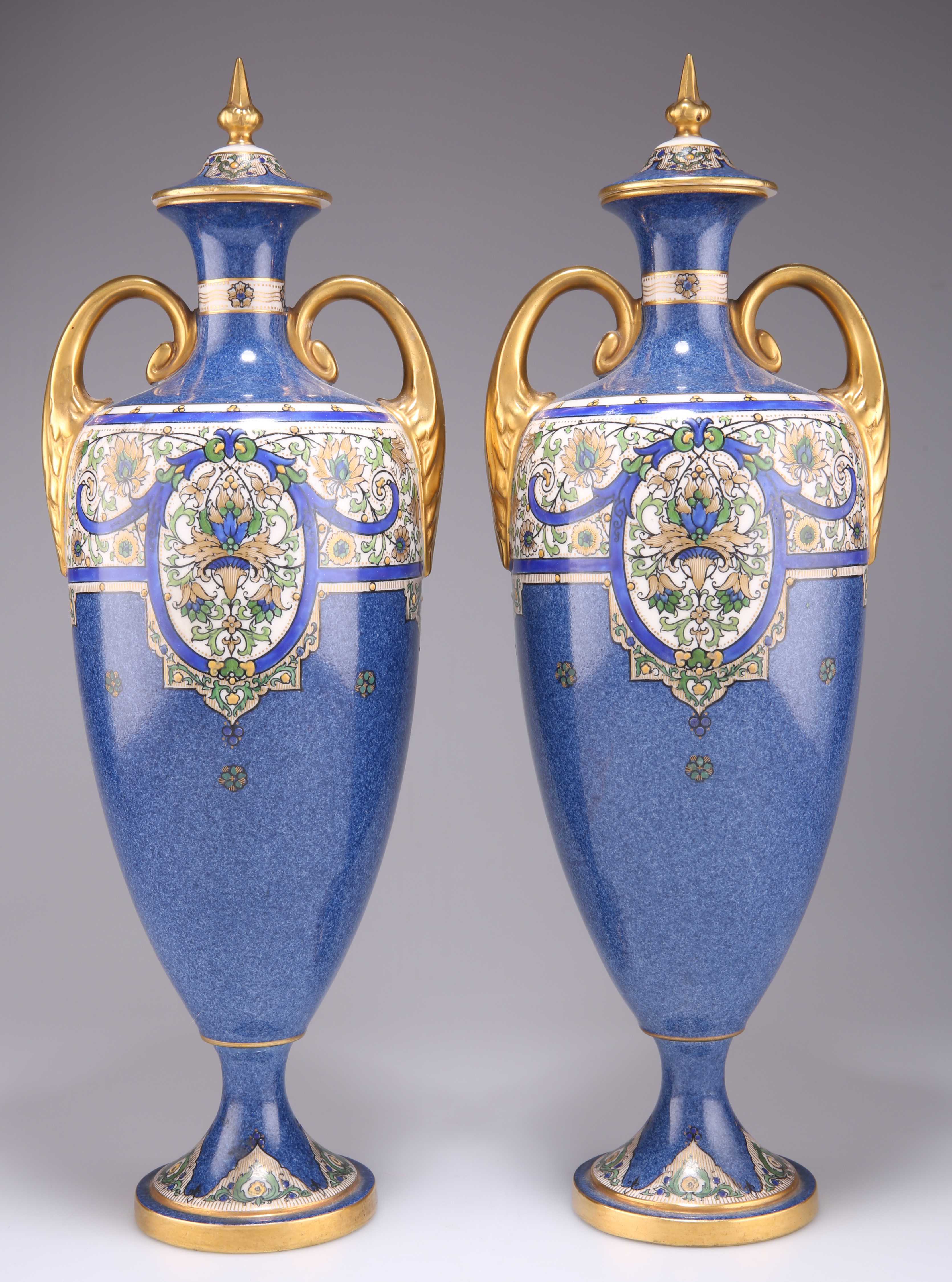 A PAIR OF ROYAL WORCESTER TWO-HANDLED VASES AND COVERS