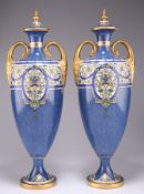 A PAIR OF ROYAL WORCESTER TWO-HANDLED VASES AND COVERS