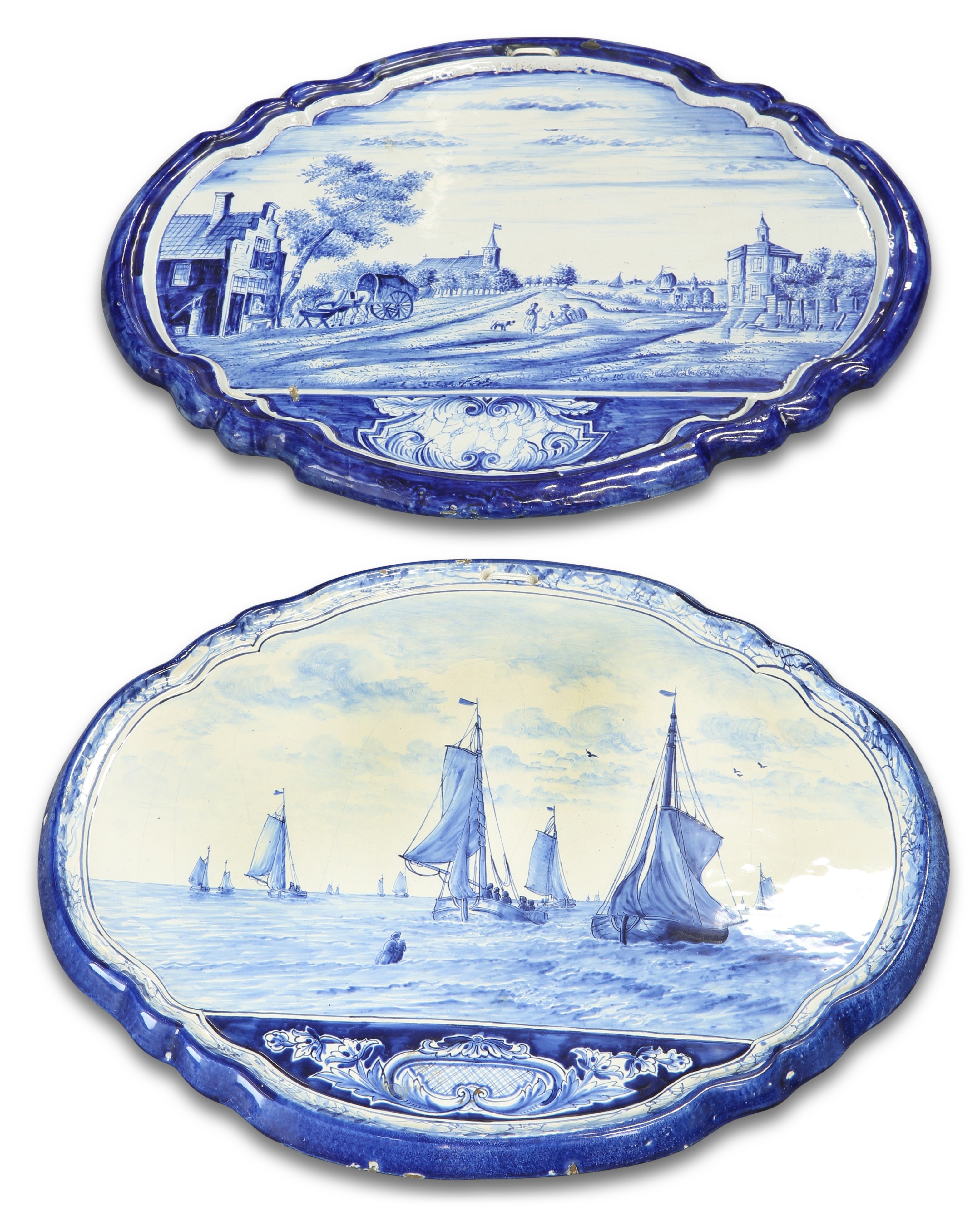 TWO SIMILAR DUTCH DELFT BLUE AND WHITE SHAPED OVAL WALL PLAQUES