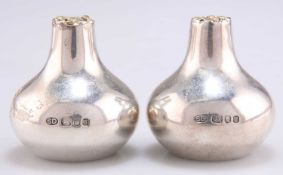 A PAIR OF ELIZABETH II SILVER AND PARCEL-GILT SALT AND PEPPER POTS