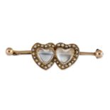 A LATE 19TH CENTURY MOONSTONE AND SEED PEARL TWIN HEART BROOCH