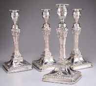 A HANDSOME SET OF FOUR EDWARDIAN SILVER CANDLESTICKS