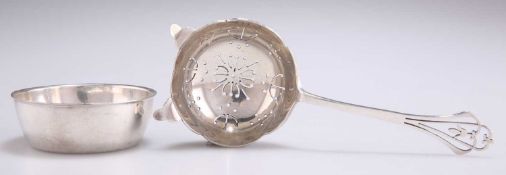 AN ELIZABETH II SILVER TEA STRAINER ON STAND