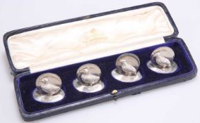 A SET OF FOUR GEORGE V SILVER MENU HOLDERS