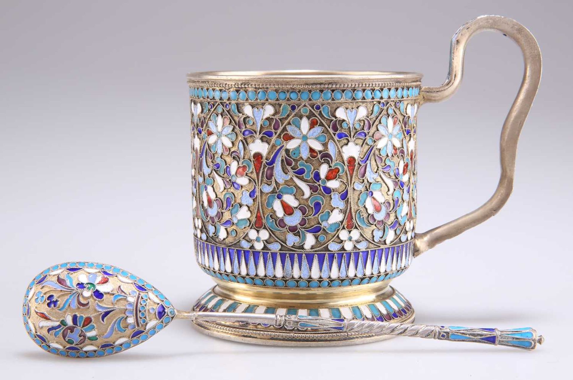 A RUSSIAN SILVER-GILT AND ENAMEL MUG AND SPOON
