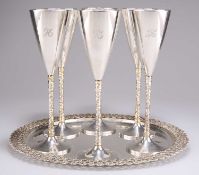 A SET OF SIX ELIZABETH II PARCEL-GILT SILVER CHAMPAGNE FLUTES ON TRAY