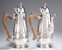 A PAIR OF VICTORIAN BRITANNIA STANDARD SILVER SIDE-HANDLED CHOCOLATE POTS