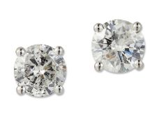 A PAIR OF SOLITAIRE DIAMOND EARRINGS