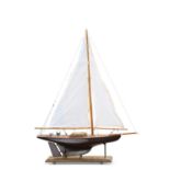 A 1930S WOODEN POND YACHT AND A DIORAMA OF SAILOR'S KNOTS