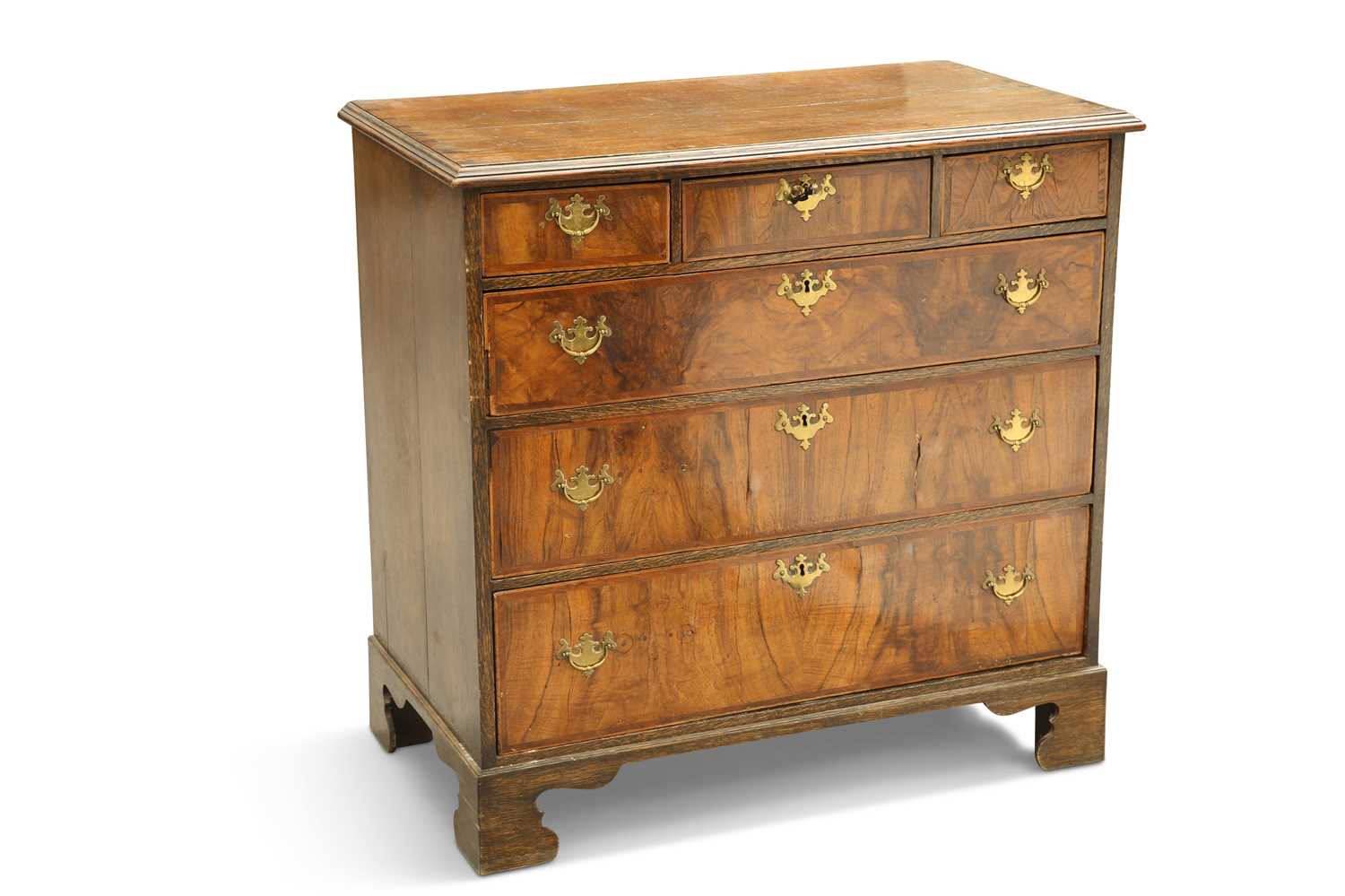 AN OAK AND WALNUT CHEST OF DRAWERS