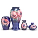 FOUR WALTER MOORCROFT ANEMONE PATTERN TUBE LINED POTTERY VASES