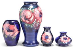 FOUR WALTER MOORCROFT ANEMONE PATTERN TUBE LINED POTTERY VASES