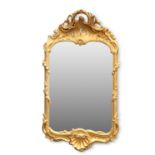 A ROCOCO REVIVAL CARVED GILTWOOD MIRROR