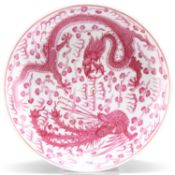 A CHINESE PUCE DECORATED 'DRAGON AND PHOENIX' DISH