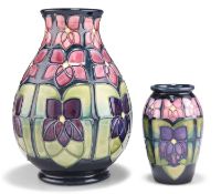 TWO MOORCROFT VIOLET PATTERN TUBE LINED POTTERY VASES