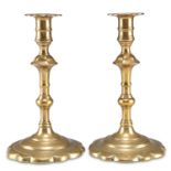 A PAIR OF 18TH CENTURY BRASS PETAL-BASE CANDLESTICKS,