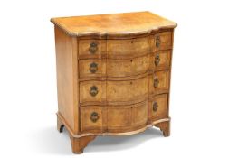 A CONTINENTAL WALNUT SERPENTINE CHEST OF DRAWERS, IN 18TH CENTURY STYLE