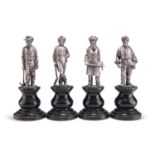A SET OF FOUR HEAVY CAST FIGURES OF SILVER MINERS