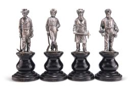 A SET OF FOUR HEAVY CAST FIGURES OF SILVER MINERS