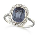 AN EARLY 20TH CENTURY SYNTHETIC COLOUR-CHANGE SAPPHIRE AND DIAMOND CLUSTER RING