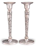 A PAIR OF CHINESE EXPORT SILVER CANDLESTICKS