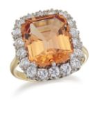 AN IMPERIAL TOPAZ AND DIAMOND CLUSTER RING