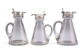 THREE GEORGE V SILVER-MOUNTED GLASS WHISKY TOTS