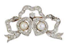 AN EARLY 20TH CENTURY SPLIT PEARL AND DIAMOND BROOCH