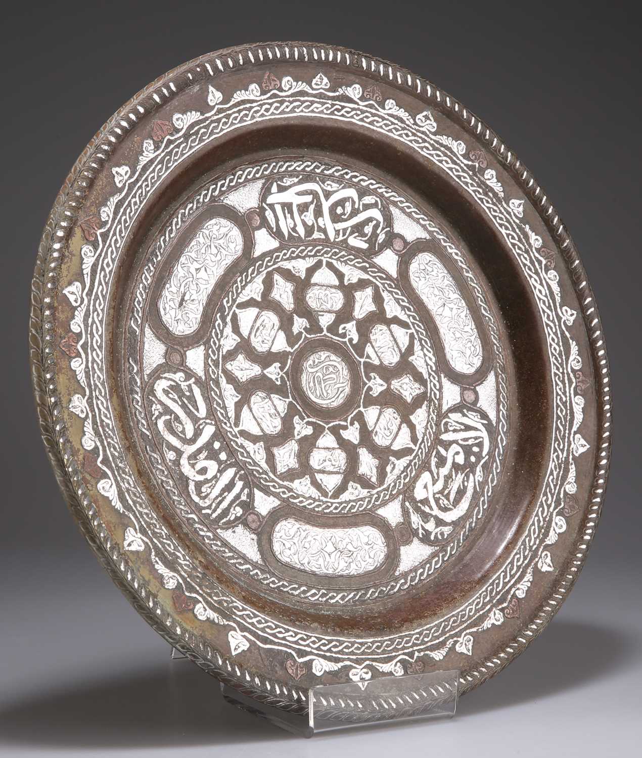 AN ISLAMIC SILVER AND COPPER ON BRASS DISH