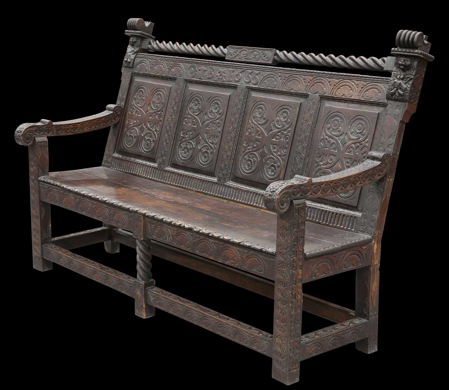 A VICTORIAN CARVED OAK SETTLE