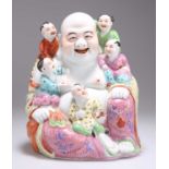 A CHINESE FAMILLE ROSE FIGURE OF A LAUGHING BUDDHA AND CHILDREN