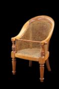 A VICTORIAN BEECH AND CANEWORK CHILD'S BERGERE CHAIR