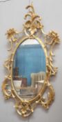 A ROCOCO STYLE GILT-COMPOSITION MIRROR