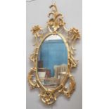 A ROCOCO STYLE GILT-COMPOSITION MIRROR