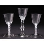 TWO 18TH CENTURY OPAQUE TWIST SMALL WINE GLASSES AND A FACETED STEM WINE GLASS