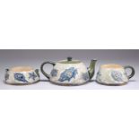 A JAMES MACINTYRE & CO GESSO FAÏENCE TEA FOR ONE THREE-PIECE TEA SET