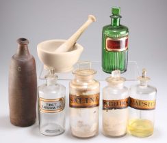 A GROUP OF CLEAR AND COLOURED GLASS APOTHECARY BOTTLES