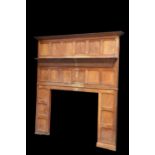 A VICTORIAN OAK PANELLED FIRE SURROUND