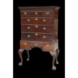 A GEORGE III MAHOGANY CHEST ON STAND