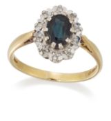 AN 18 CARAT GOLD GREEN SAPPHIRE AND DIAMOND CLUSTER RING