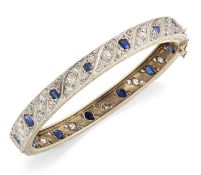 AN EARLY 20TH CENTURY SAPPHIRE AND DIAMOND HINGE OPENING BANGLE