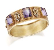 A LATE 19TH CENTURY AMETHYST AND SEED PEARL HINGE OPENING BANGLE