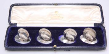 A SET OF FOUR GEORGE V SILVER MENU HOLDERS