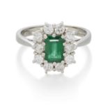 A PLATINUM EMERALD AND DIAMOND CLUSTER RING