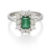 A PLATINUM EMERALD AND DIAMOND CLUSTER RING